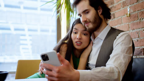 Couple-using-smartphone-indoors