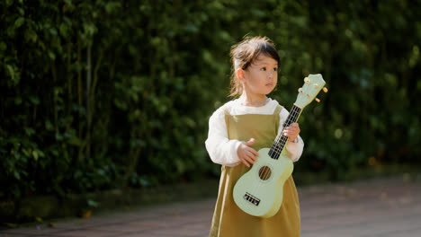 Child-with-musical-instrument-outdoors