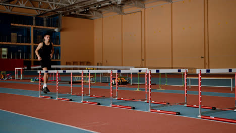 Male-athlete-jumping-hurdles
