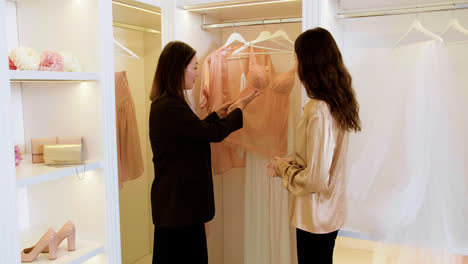 Asian-and-caucasian-woman-in-wedding-dress-shop