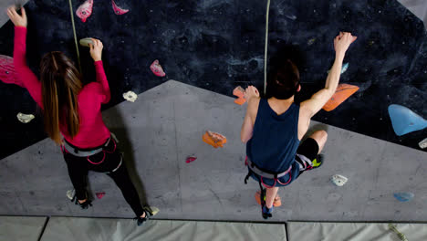 Teenage-boy-and-girl-climbing-indoors