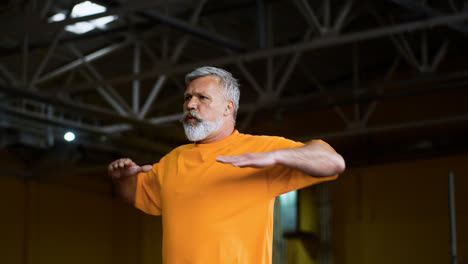 Senior-man-stretching-indoors