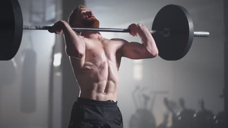 Athletic-Beautiful-man-Does-Overhead-Deadlift-with-a-Barbell-in-the-Gym.-Gorgeous-male-Professional-Bodybuilder-Workout-Weight-Lift-Exercises-in-the-Authentic-Fit-Training-Facility
