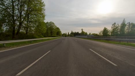 Outside-view-of-a-car-driving-fast-on-a-smooth-freeway