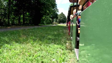 People-Enjoy-Riding-the-Palace-Garden-Railway-in-the-Palace-Garden-in-Karlsruhe,-Germany---First-Person-View