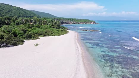 Vuelo-Con-Drones-Sobre-El-Paraíso-Con-Playa-De-Arena,-Aguas-Cristalinas-Del-Océano-Y-Arrecifes-De-Coral-En-República-Dominicana-En-Verano