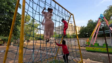 Little-kids-are-climbing-the-chain-with-both-hands-and-feet-and-playing-army-and-police-games