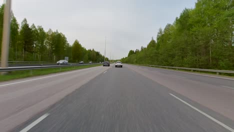 A-car-moving-rapidly-on-a-multi-lane-motorway-as-seen-from-outside