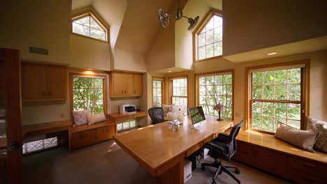 push-in-shot-of-a-large-home-office-with-large-windows-and-wood-accents