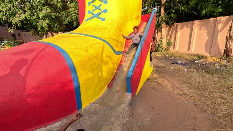 Small-children-are-playing-the-game-of-sliding-in-a-very-big-sliding-ride