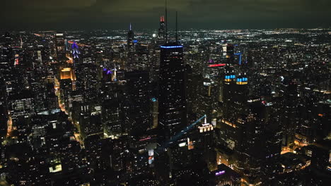 Aerial-view-around-the-illuminated-Streeterville-skyline,-nighttime-in-Chicago
