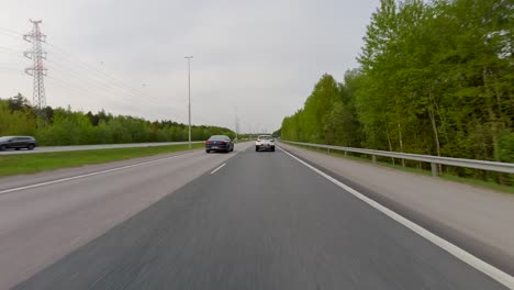 Ein-Auto,-Das-Sehr-Schnell-Auf-Einer-Von-Wunderschönen-Bäumen-Gesäumten-Autobahn-Fährt