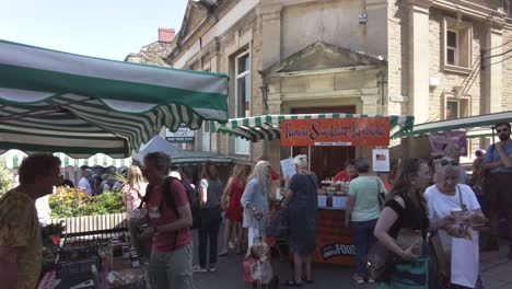 People-enjoy-an-open-air-market-in-a-small-English-town