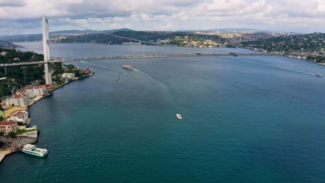 Connecting-worlds:-Istanbul's-bridges-shine-in-stunning-drone-shots,-with-boats-adding-life-to-the-sparkling-Bosphorus