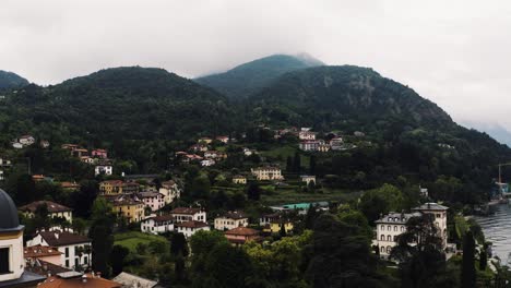 Aerial-view-pulling-away-from-Bellagio's-quaint-town-in-Italy's-rural-countryside