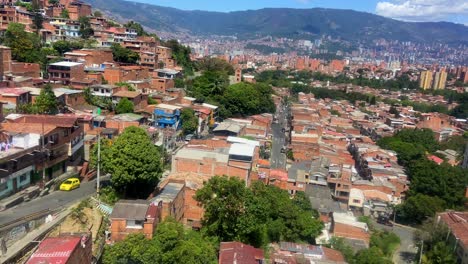 Inside-cable-car-views-of-Medellin-shantytown-with-skyscrapers-in-background