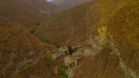 Drone-footage-of-a-waterfall-in-the-middle-of-the-desertic-mountains