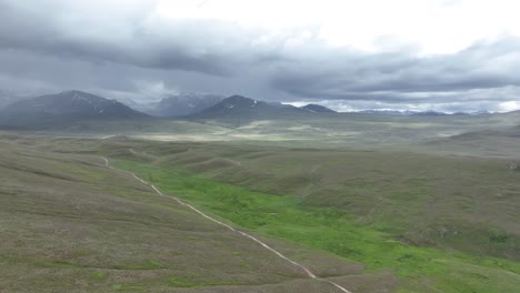Aerial-shot-of-Deosai-National-Park-in-Skardu-Gilgit-Baltistan,-with-the-clouds-converted-mountain-in-the-background