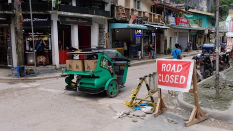 Filipino-tricycle-taxi-automobile-driving-down-the-streets-of-El-Nido-in-Palawan,-Philippines,-Southeast-Asia