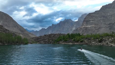 Aerial-View-Of-Jet-ski-Going-Across-Upper-Kachura-Lake-Skardu-With-Mountain-Landscape-In-Distance