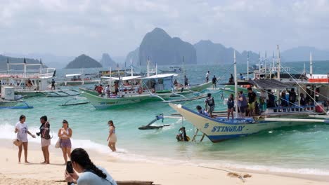 Island-hopping-tour-boats-packed-with-tourist-visiting-popular-Seven-Commandos-beach-from-El-Nido-in-Palawan,-Philippines,-Southeast-Asia