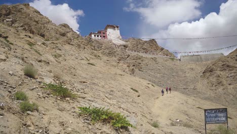 People-walking-towards-Namgyal-Tsemo-Gompa-or-Budhhist-Monastery-in-Upper-Himalayas-of-Leh-Ladakh-India