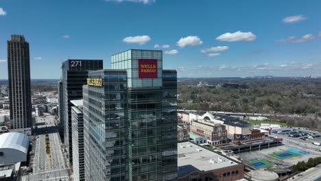 Drone-orbits-around-the-Wells-Fargo-Bank-office-building-and-reveals-traffic-movement-across-the-freeway-and-iconic-skyscrapers-in-the-background