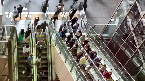 Tracking-shot-of-commuters-using-the-escalators-during-rush-hour-at-Osaka-Train-Station