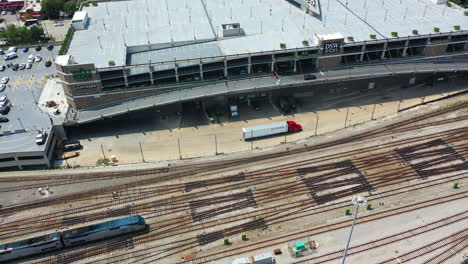 Aerial-pan-shot-tracking-a-AMTRAK-train,-arriving-at-the-Union-station-in-Chicago