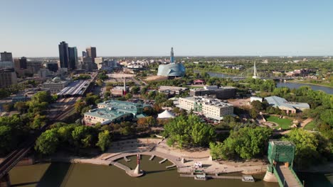 Beautiful-high-aerial-of-the-Forks-and-downtown-Winnipeg,-Manitoba,-Canada