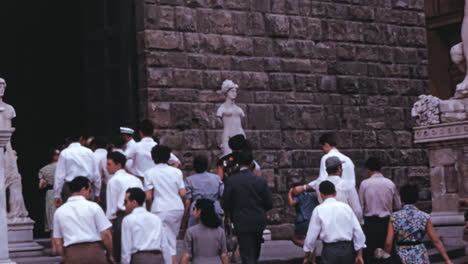 Tourist-in-1970s-walking-in-slow-motion-in-cultural-Florence-city-center-in-Italy,-Archival-footage-of-vintage-tourism