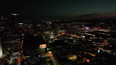 Panoramic-aerial-view-of-Downtown-Atlanta-skylines-illuminated-with-night-light,-Mercedes-Benz-Stadium,-CNN-building,-Giant-Ferris-Wheel