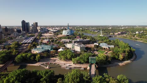Long-and-high-aerial-pan-of-Winnipeg-skyline,-rich-colors-in-late-summer