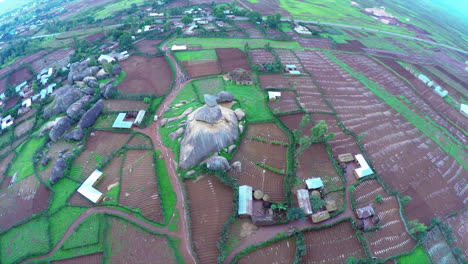 Farming-community-in-the-Plateau-State-of-Nigeria-with-an-iconic-rock-formation---aerial
