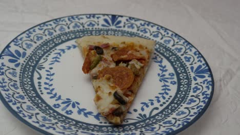 Slice-of-loaded-pizza-on-a-plate