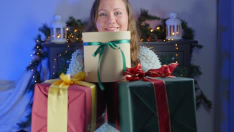 Generous-brunette-giving-three-big-wrapped-Christmas-gift,-portrait-view