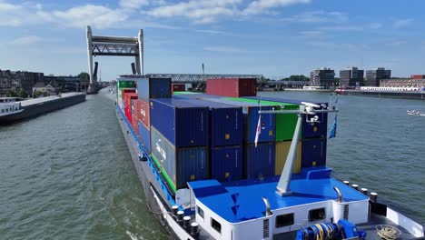 On-the-Oude-Maas-river-at-Dordrecht-the-container-vessel-the-Amazone,-aerial