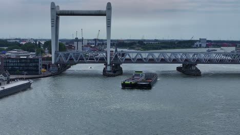 Container-Barge-passed-under-Railway-Bridge-across-Oude-Maas-River,-Dordrecht,-Netherlands