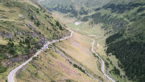 Sheer-drop-off-next-to-pull-offs-showcase-large-u-bend-in-Transfagarasan-Serpentine-Road-cutting-through-romanian-forests