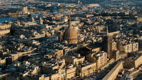 Drone-shot-circling-the-Bażilika-Santwarju-tal-Madonna-tal-Karmnu,-sunny-evening-in-Valletta,-Malta