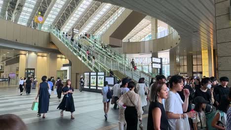 Static-shot-of-commuters-walking-through-Osaka-train-station-trying-to-reach-the-underground