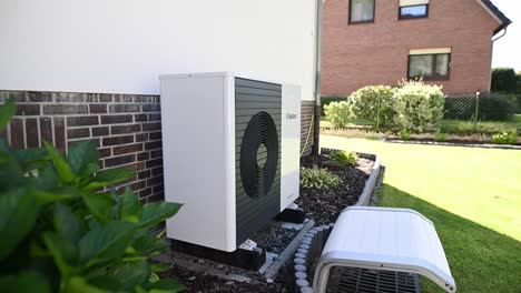 A-heat-pump-from-Vaillant-is-installed-on-the-outside-wall-of-a-single-family-house-and-heats-the-building-with-clean,-sustainably-produced-electricity