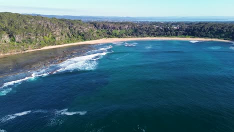 Drone-aerial-landscape-bushland-shot-of-sandy-beach-bay-nature-travel-tourism-ocean-waves-NSW-Bateau-Bay-Central-Coast-Australia-4K