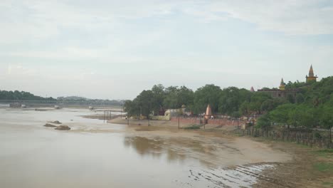 Panoramic-view-of-dry-riverbed-with-leftover-water-in-summer-heat-weather,-Bodhgaya,-Bihar,-India