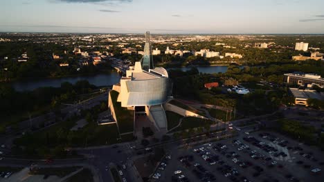 An-Orange-Reflection-Sunset-Golden-Hour-Aerial-View-of-the-Urban-Park-Canadian-Museum-for-Human-Rights-The-Forks-Market-Downtown-Winnipeg-Shaw-Park-Provencher-Bridge-Red-River-in-Manitoba-Canada