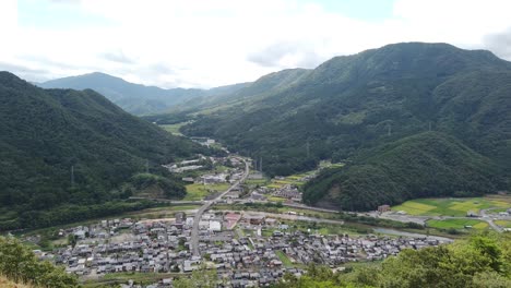 Takeda-Castle-Viewpoint-of-the-Asago-City-and-Valley-Panning,-Japan,-Aerial-Shot