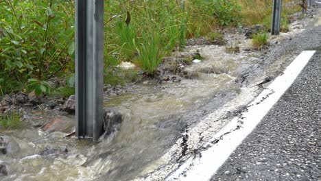 Rainwater-runoff-eroding,-damaging-road,-infrastructure-in-western-Norway