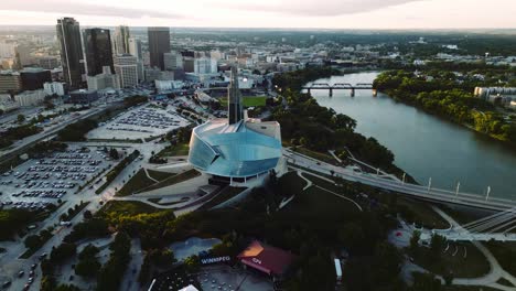 A-Far-Away-Sunset-Golden-Hour-Aerial-View-of-the-Urban-Park-Canadian-Museum-for-Human-Rights-The-Forks-Market-Downtown-Winnipeg-Shaw-Park-Provencher-Bridge-Red-River-in-Manitoba-Canada