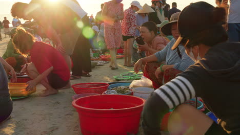 Busy-crowded-fresh-fish-market-as-seafaring-people-sell-variety-of-shellfish-in-plastic-basket-bowls
