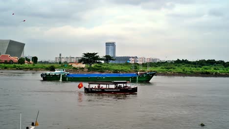 Various-types-of-watercraft-regularly-traverse-the-clean-and-calm-Saigon-River,-a-central-tourist-attraction-in-Ho-Chi-Minh-City,-Vietnam